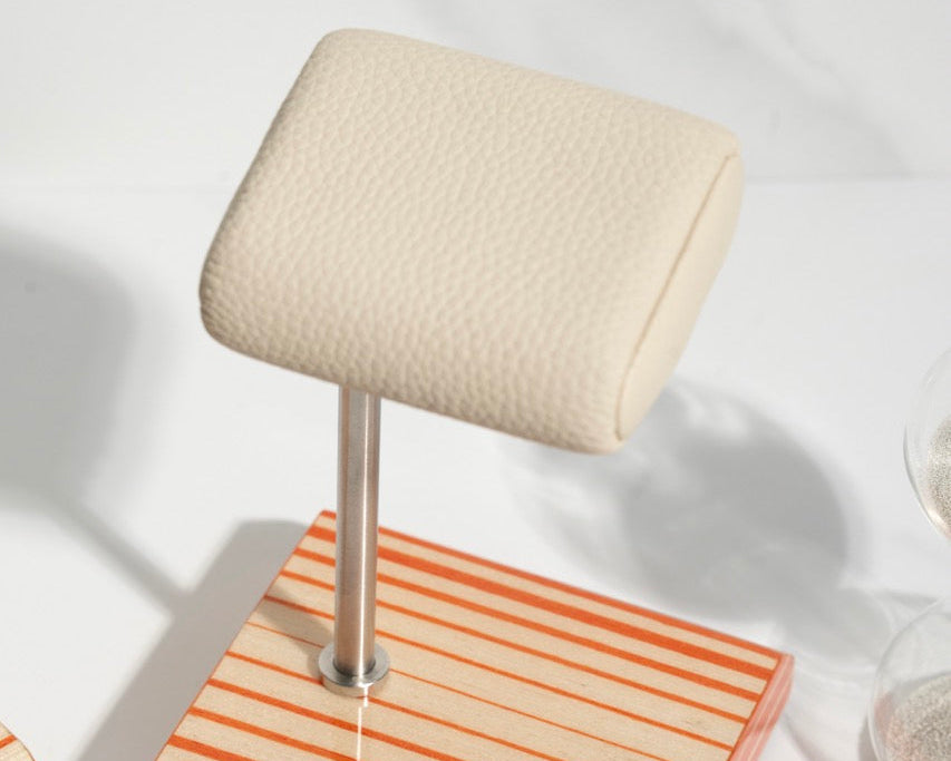 white leather and orange watch stand